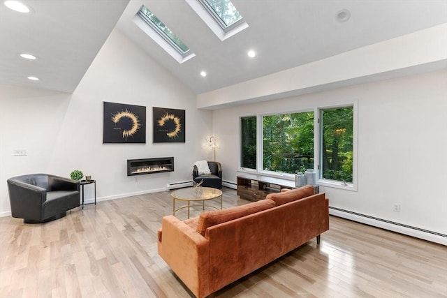 11 Running Stream Rd, Rehoboth, MA 02769 - living area featuring a glass covered fireplace, a baseboard radiator, wood finished floors, a skylight, and high vaulted ceiling