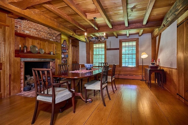 dining space with beam ceiling, wooden ceiling, and wood-type flooring