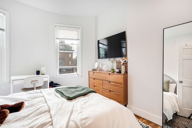 bedroom with hardwood / wood-style flooring