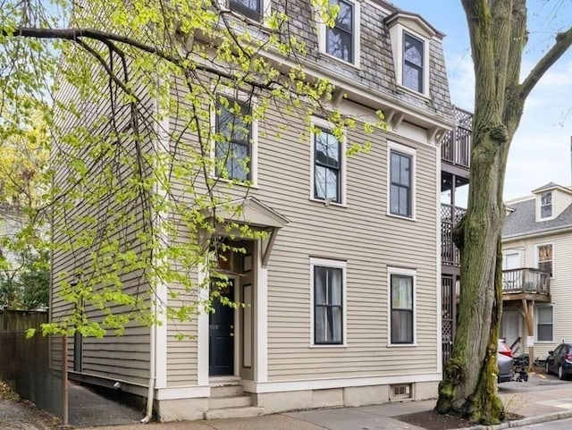 exterior space with mansard roof and entry steps