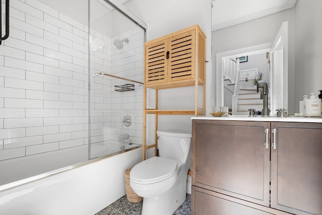 full bathroom with combined bath / shower with glass door, vanity, toilet, and tile patterned floors