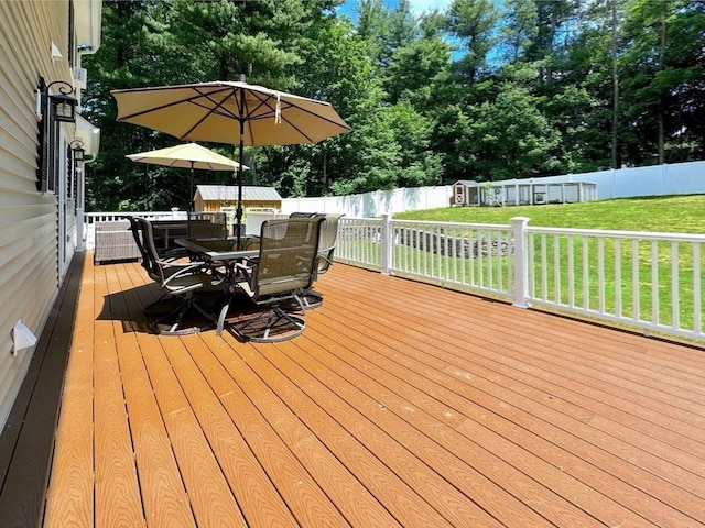111 Country Club Pl, Southbridge, MA 01550 - wooden deck with a storage shed, outdoor dining space, a fenced backyard, and view of wooded area