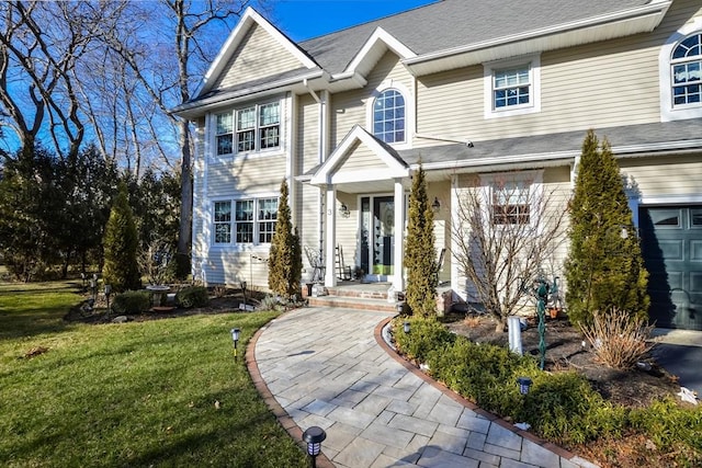 view of front of property featuring a garage and a front yard