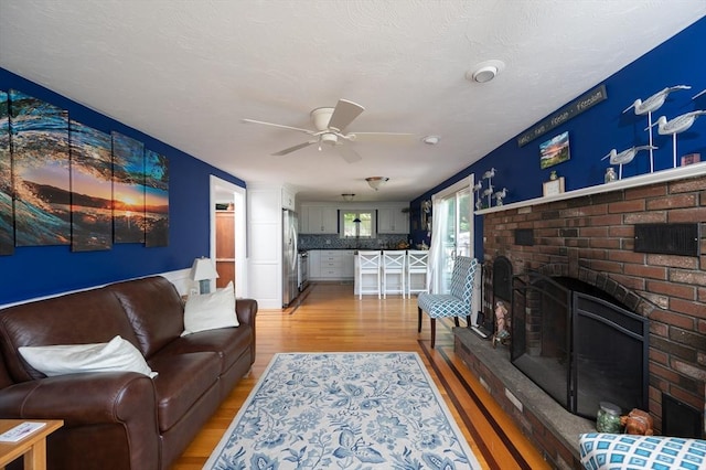 29 Wituwamat Rd, Weymouth, MA 02191 - living area with light wood finished floors, ceiling fan, and a fireplace