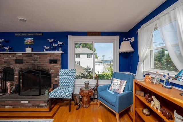 29 Wituwamat Rd, Weymouth, MA 02191 - living area with a brick fireplace and wood finished floors