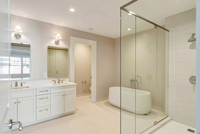 128 Elm St Unit 210, Cohasset, MA 02025 - full bath with a soaking tub, a stall shower, double vanity, toilet, and recessed lighting