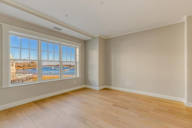 128 Elm St Unit 210, Cohasset, MA 02025 - empty room with light wood-style flooring, baseboards, and crown molding