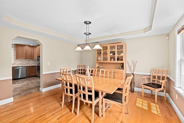 102 Saddleworth Way, Middleboro, MA 02346 - dining area featuring a tray ceiling, arched walkways, and light wood finished floors