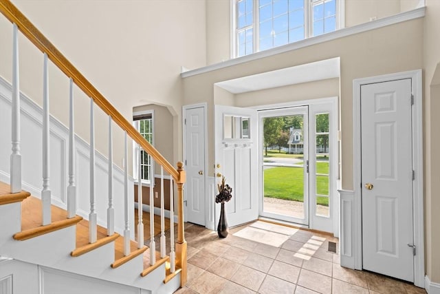 102 Saddleworth Way, Middleboro, MA 02346 - foyer featuring light tile patterned flooring, a high ceiling, stairway, and arched walkways