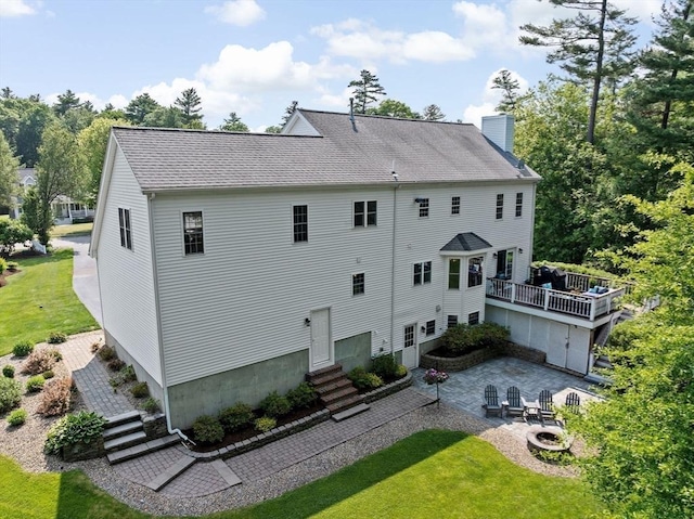 102 Saddleworth Way, Middleboro, MA 02346 - back of property featuring an outdoor fire pit, a chimney, a lawn, entry steps, and a patio