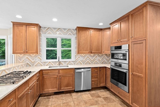 102 Saddleworth Way, Middleboro, MA 02346 - kitchen featuring stainless steel appliances, decorative backsplash, brown cabinets, recessed lighting, and light countertops