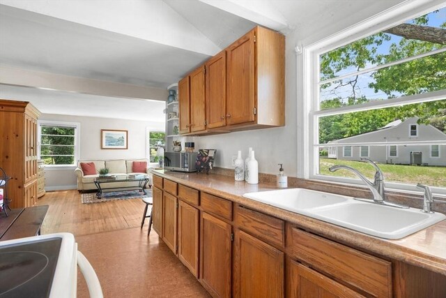 22 Wallace Pt, Bourne, MA 02532 - kitchen with a sink, light countertops, brown cabinets, light wood finished floors, and range