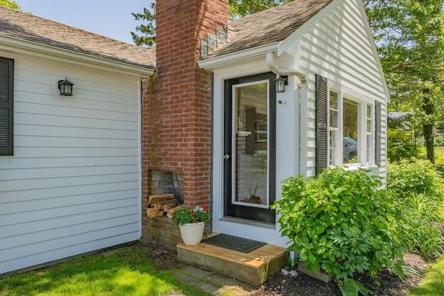 22 Wallace Pt, Bourne, MA 02532 - view of exterior entry with a chimney and brick siding