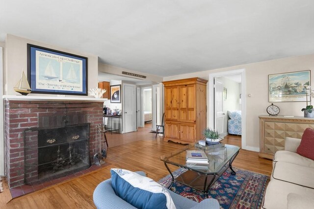 22 Wallace Pt, Bourne, MA 02532 - living area featuring wood finished floors, a fireplace, and baseboards