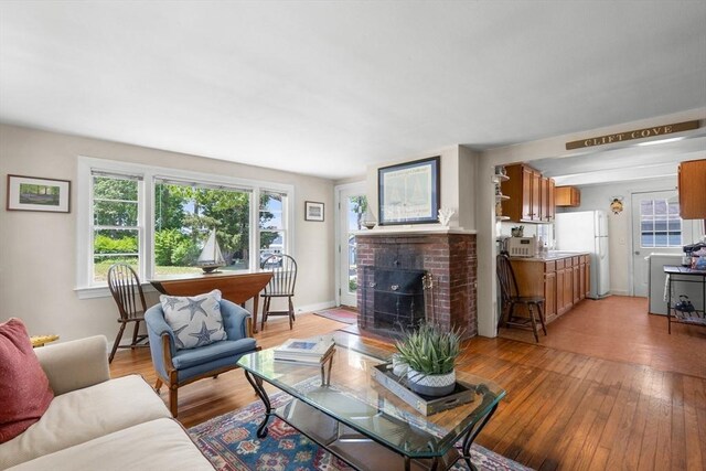 22 Wallace Pt, Bourne, MA 02532 - living area with a brick fireplace and light wood-type flooring