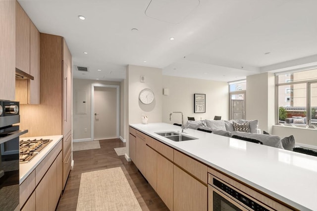 43 Westland Ave Unit 512, Boston, MA 02115 - kitchen featuring open floor plan, light countertops, stainless steel gas cooktop, a sink, and visible vents