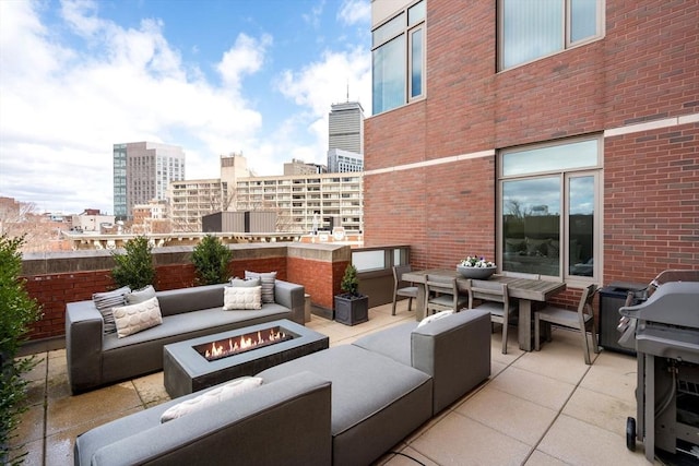 43 Westland Ave Unit 512, Boston, MA 02115 - view of patio / terrace with a view of city and an outdoor living space with a fire pit