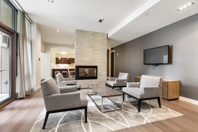 43 Westland Ave Unit 512, Boston, MA 02115 - living room with a stone fireplace, baseboards, and wood finished floors