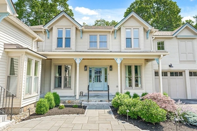 4 Norwood St, Winchester, MA 01890 - view of front of property featuring covered porch, a garage, and driveway