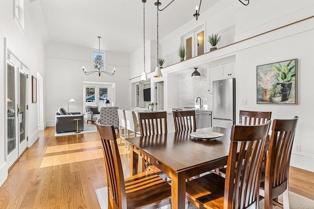 4 Norwood St, Winchester, MA 01890 - dining area with light wood finished floors, a chandelier, and a towering ceiling
