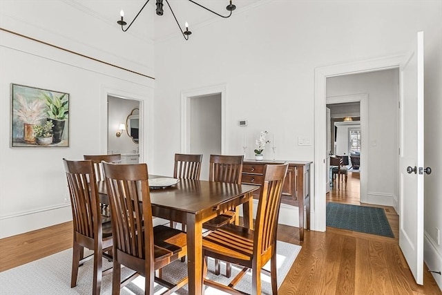 4 Norwood St, Winchester, MA 01890 - dining room with light wood-type flooring, a chandelier, and crown molding