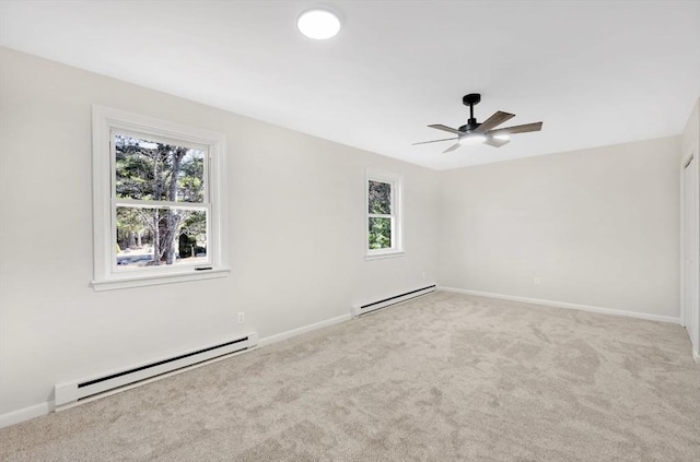 empty room with a baseboard radiator, carpet floors, and baseboards