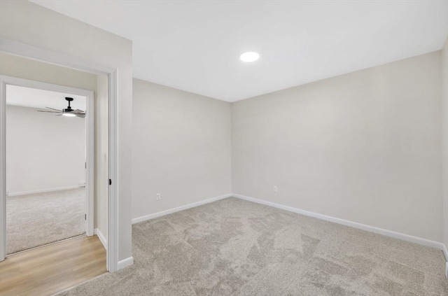 carpeted spare room featuring baseboards