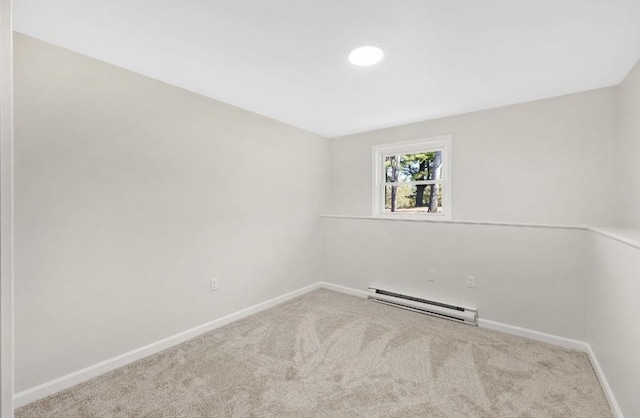 carpeted spare room featuring baseboards and baseboard heating