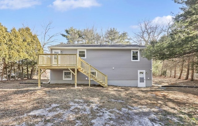 back of house featuring stairs and a deck