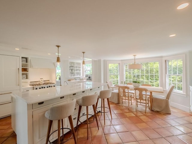 11 Water St, Duxbury, MA 02332 - kitchen with recessed lighting, a breakfast bar area, an island with sink, light countertops, and open shelves