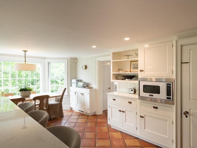 11 Water St, Duxbury, MA 02332 - kitchen featuring stainless steel microwave, healthy amount of natural light, white cabinetry, ornamental molding, and recessed lighting