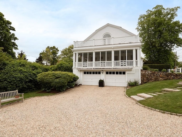 11 Water St, Duxbury, MA 02332 - view of front of home with driveway, a sunroom, a balcony, a front yard, and an attached garage