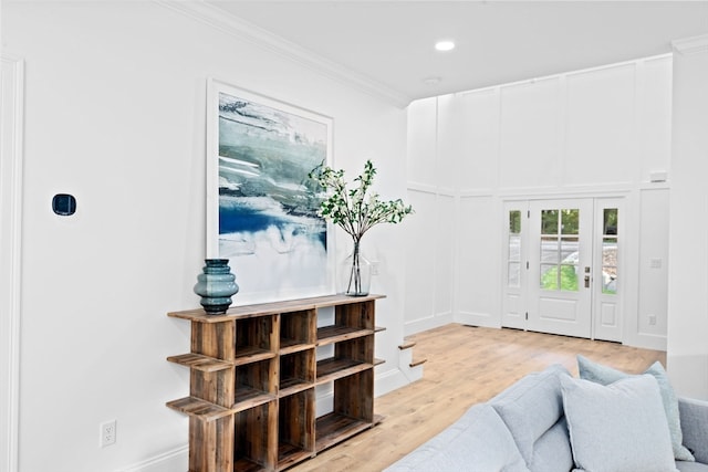 entryway featuring crown molding and light hardwood / wood-style flooring