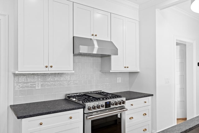 kitchen with stainless steel range, decorative backsplash, white cabinets, and crown molding