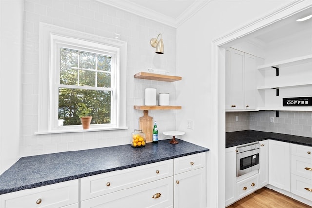 kitchen with white cabinetry, a healthy amount of sunlight, and light wood-type flooring