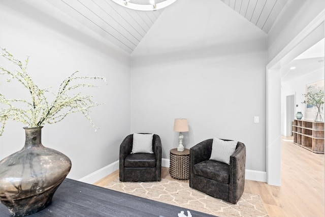 sitting room featuring vaulted ceiling, wood ceiling, and light hardwood / wood-style floors