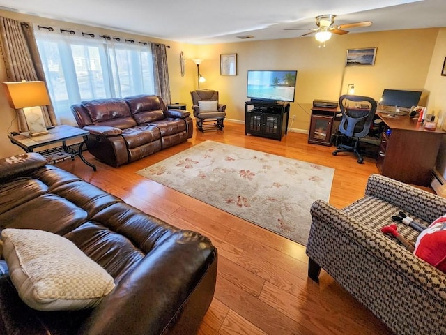 living room featuring hardwood / wood-style flooring and ceiling fan