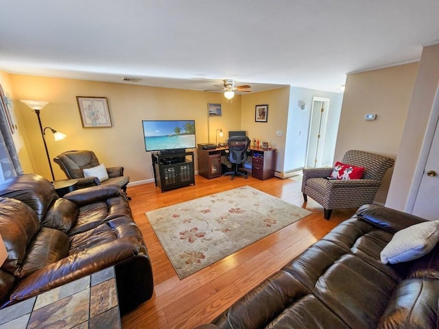 living room with ceiling fan and light wood-type flooring