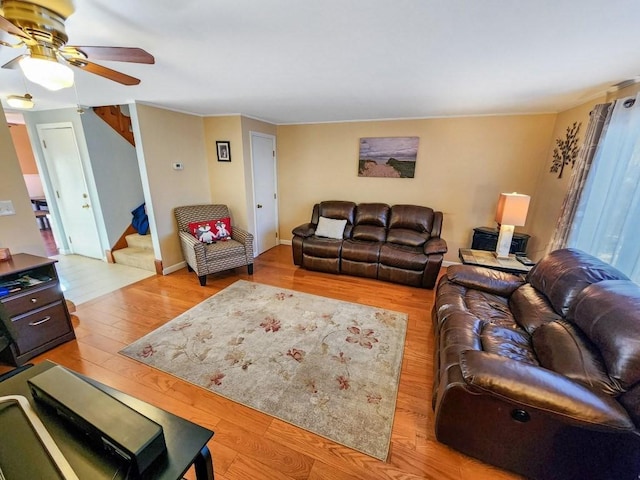 living room with light wood-type flooring and ceiling fan