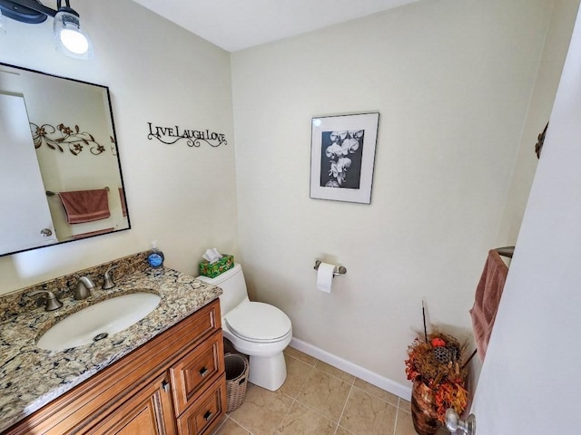 bathroom with tile patterned flooring, vanity, and toilet