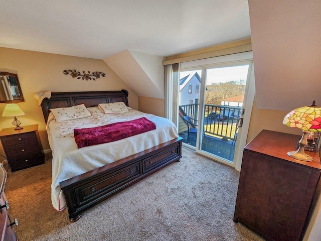 bedroom featuring access to exterior, light carpet, and vaulted ceiling