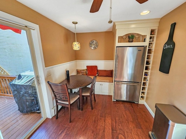 dining space featuring dark hardwood / wood-style flooring, built in features, and ceiling fan