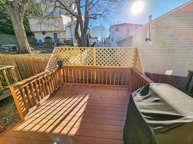 wooden deck with a grill