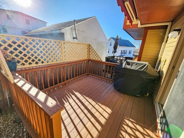 wooden terrace with a grill