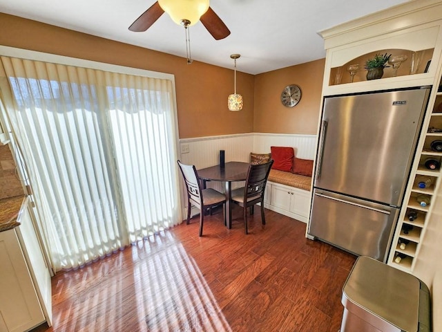 dining room featuring ceiling fan and dark hardwood / wood-style flooring