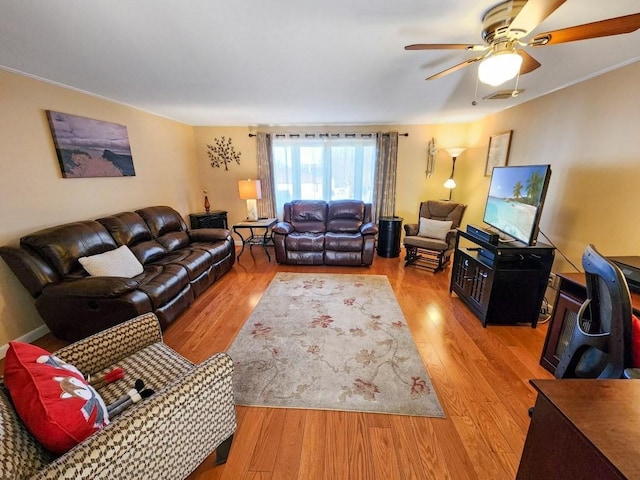 living room featuring ceiling fan and light hardwood / wood-style floors