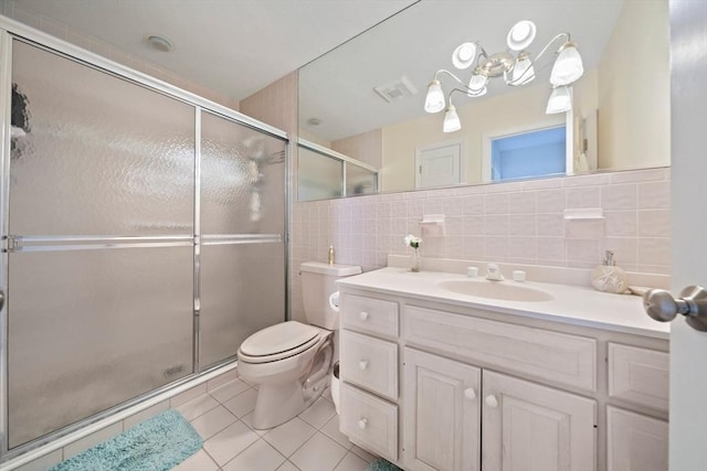 full bath featuring tile patterned flooring, tile walls, toilet, and a shower stall