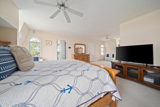 bedroom featuring a ceiling fan, multiple windows, and light colored carpet