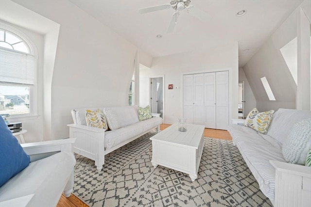 living area with a ceiling fan, lofted ceiling, and recessed lighting