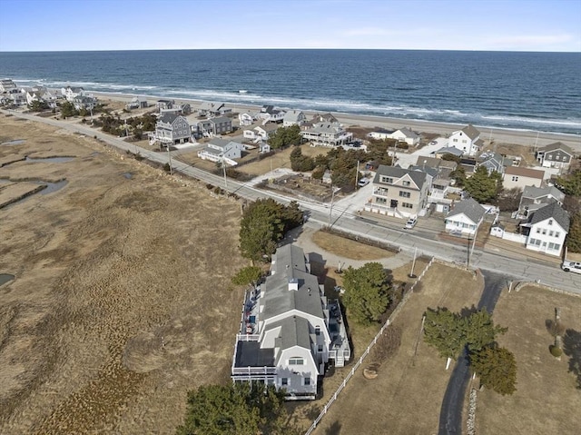 birds eye view of property featuring a residential view, a water view, and a beach view